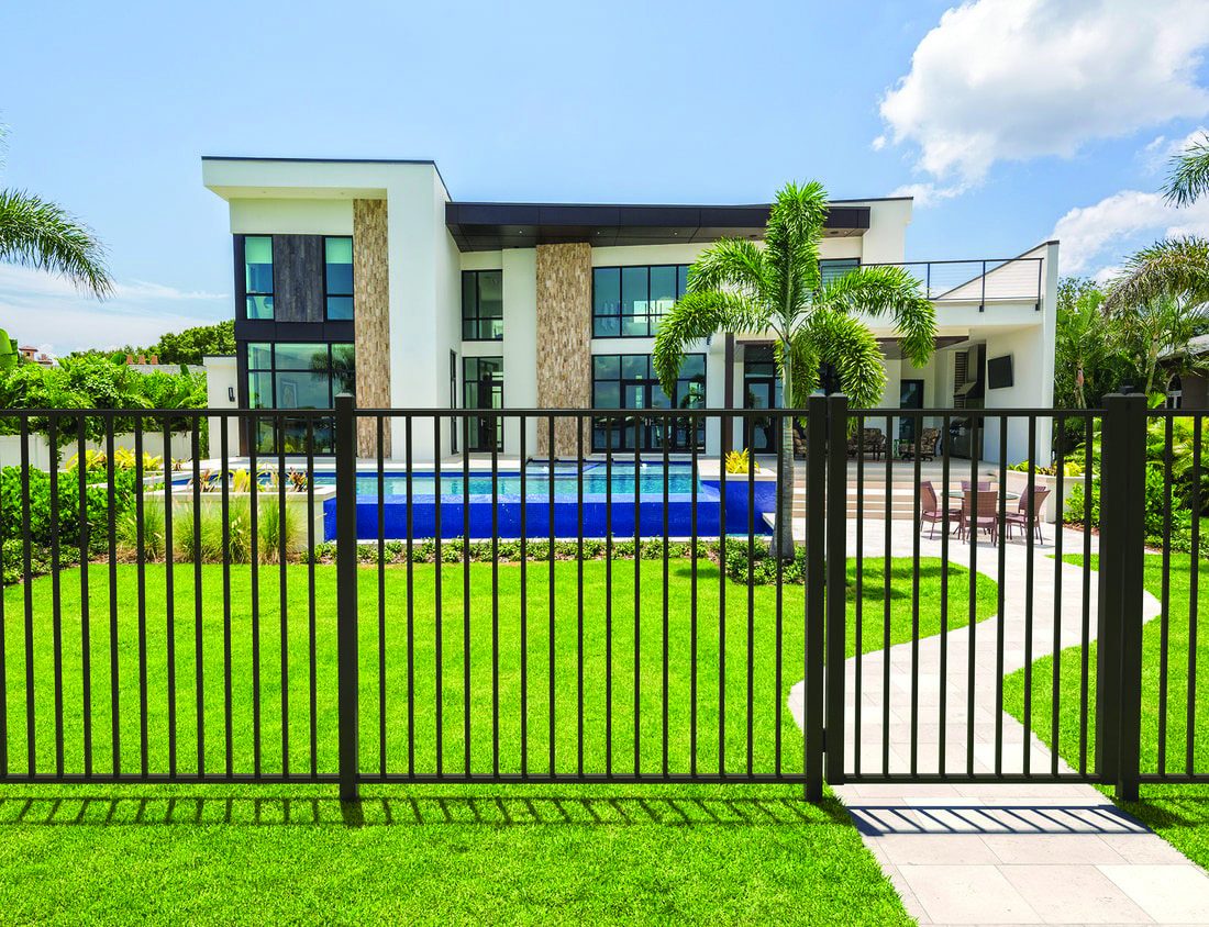 Aluminum fence framing a modern home